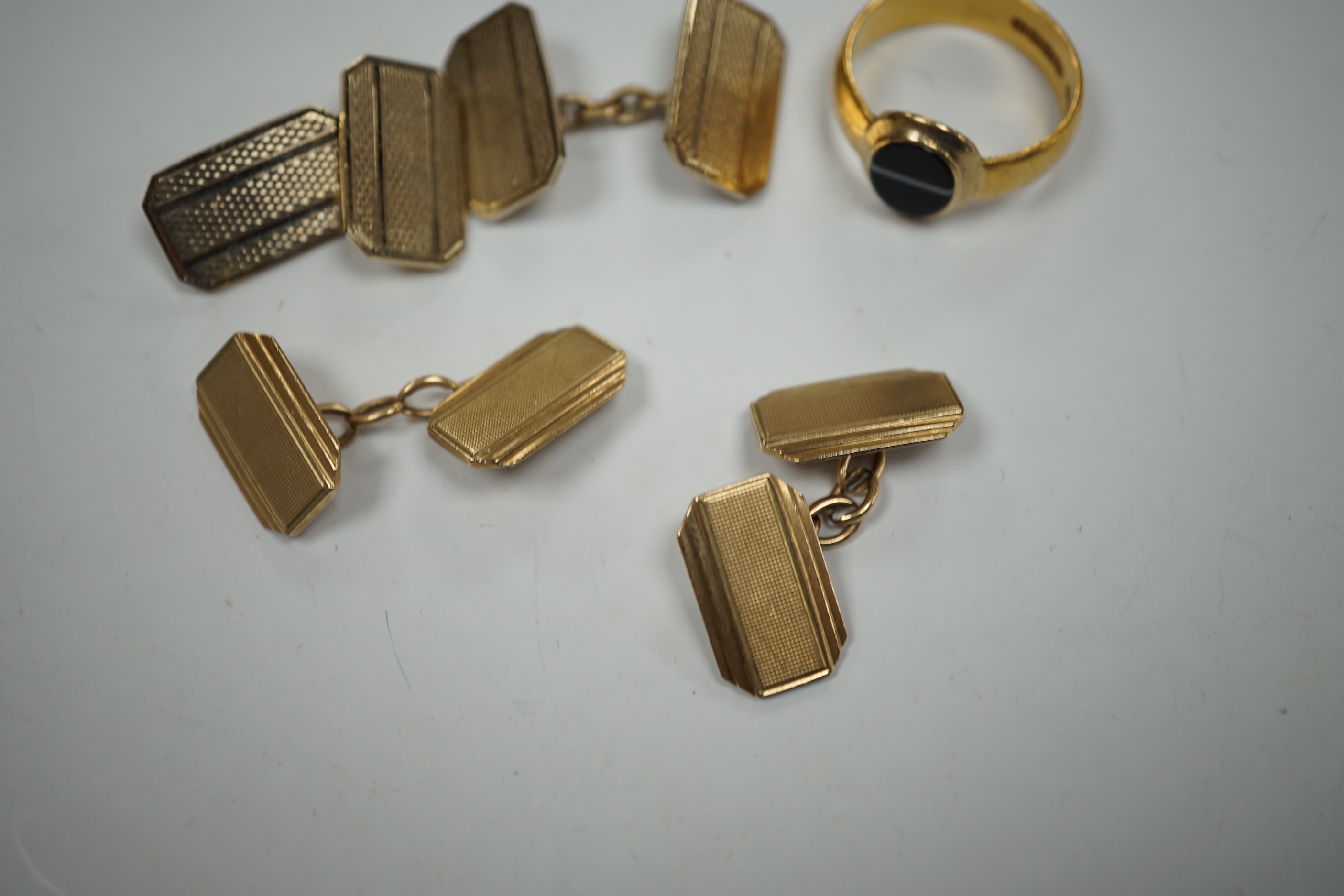 A 1930's part 22ct gold and banded black onyx set signet ring, (the ring head later associated), size Q/R, gross weight 6.8 grams, a pair of engine turned 9ct gold cufflinks, 8.5 grams and one other pair of cufflinks.